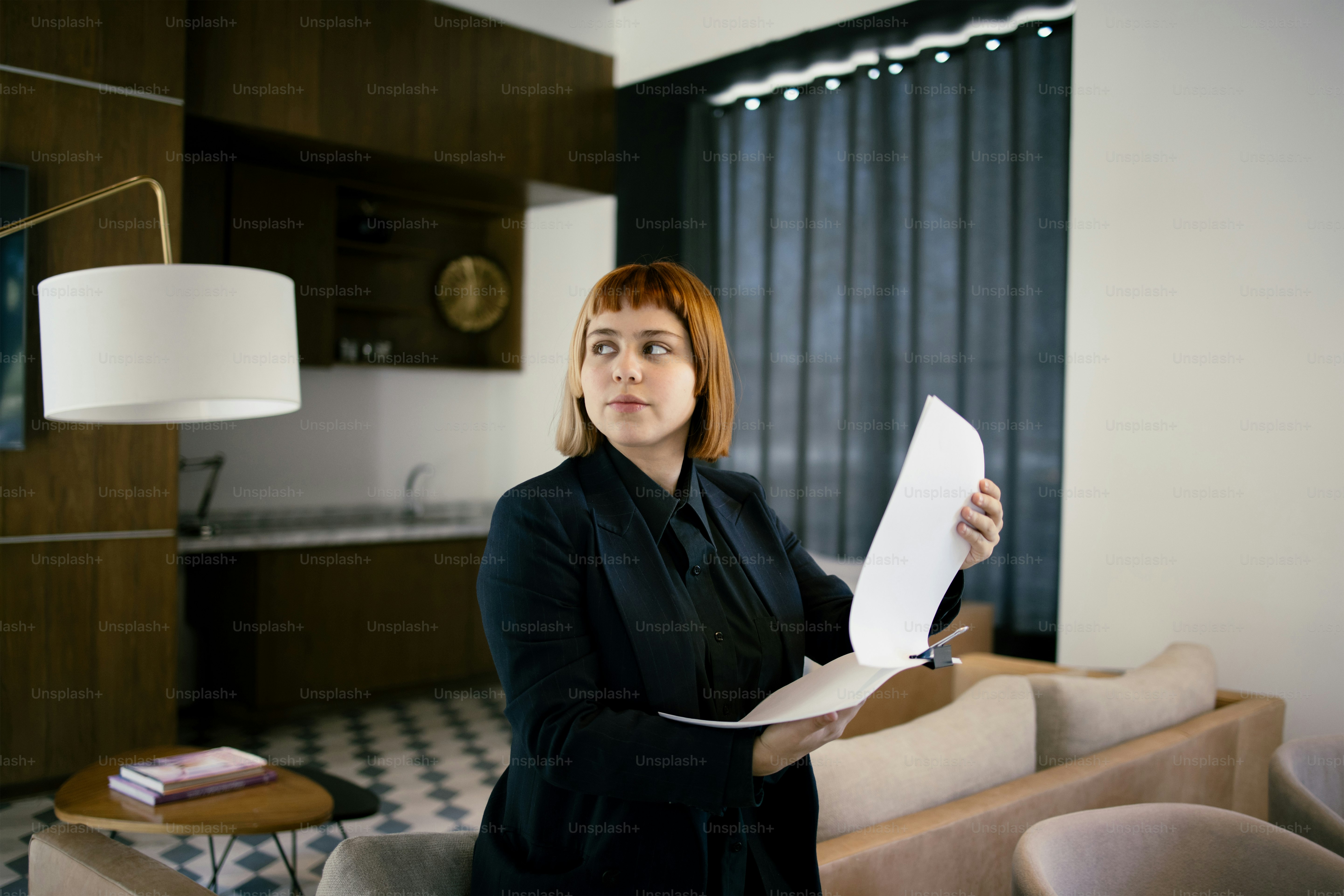 Woman reviews documents in a modern office setting.